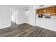 Living room features wood-look flooring and adjacent kitchen area at 14255 Rosemary Ln # 8219, Largo, FL 33774