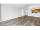 Bright living room with wood-look flooring and passthrough to kitchen at 14255 Rosemary Ln # 8219, Largo, FL 33774