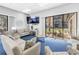 Cozy community living room featuring comfortable seating and a TV at 14255 Rosemary Ln # 8219, Largo, FL 33774