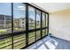 Enclosed patio with serene views of the pond and surrounding landscaping at 14255 Rosemary Ln # 8219, Largo, FL 33774