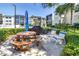 Outdoor picnic area with grill and seating, surrounded by lush greenery and well-maintained landscaping at 14255 Rosemary Ln # 8219, Largo, FL 33774