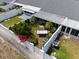 Aerial view of a private backyard with a hammock, mature landscaping, and a white privacy fence at 1655 S Highland Ave # C155, Largo, FL 33756