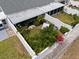 Aerial view of a private backyard with a hammock, mature landscaping, and a white privacy fence at 1655 S Highland Ave # C155, Largo, FL 33756