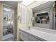Bright bathroom featuring a vanity with storage and a shower over the toilet at 1655 S Highland Ave # C155, Largo, FL 33756