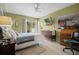 Inviting bedroom with a TV, ample natural light, and relaxing ambiance with garden views at 1655 S Highland Ave # C155, Largo, FL 33756