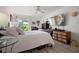 Cozy bedroom with a ceiling fan, comfortable bed, and a bright window for natural light at 1655 S Highland Ave # C155, Largo, FL 33756