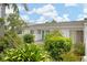 Charming condo featuring lush landscaping, a bright exterior, and a cozy courtyard at 1655 S Highland Ave # C155, Largo, FL 33756