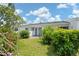 Exterior of home with a well maintained lawn and landscaping at 1655 S Highland Ave # C155, Largo, FL 33756