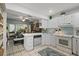 Well-lit kitchen featuring white cabinetry, modern appliances, and a seamless connection to the dining area at 1655 S Highland Ave # C155, Largo, FL 33756