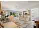 Bright living room boasting elegant furnishings, tile flooring, and seamless access to the patio at 1655 S Highland Ave # C155, Largo, FL 33756
