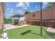 Spacious backyard with well-maintained grass and paver patio at 1725 Sommarie Way, Tarpon Springs, FL 34689