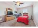 Cozy bedroom featuring a themed bed, desk area, and comfortable carpeting at 1725 Sommarie Way, Tarpon Springs, FL 34689
