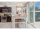 Cozy dining area featuring a modern chandelier, stylish table setting, and sliding glass door at 1725 Sommarie Way, Tarpon Springs, FL 34689
