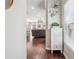 Hallway with hardwood floors leading into a living room at 1725 Sommarie Way, Tarpon Springs, FL 34689