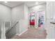 Upstairs hallway that leads to bedrooms; neutral carpet and walls at 1725 Sommarie Way, Tarpon Springs, FL 34689