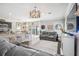 Open-concept living room with dining area and sliding glass door at 1725 Sommarie Way, Tarpon Springs, FL 34689