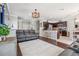 Open-concept living room and dining area with hardwood floors at 1725 Sommarie Way, Tarpon Springs, FL 34689