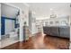 Open concept living room leading to the kitchen with wood floors and recessed lighting at 1725 Sommarie Way, Tarpon Springs, FL 34689