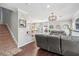 Open-concept living room with stairs and view of the kitchen at 1725 Sommarie Way, Tarpon Springs, FL 34689