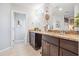 Elegant main bathroom with dual vanities, granite countertops, and a bright, inviting atmosphere at 1725 Sommarie Way, Tarpon Springs, FL 34689