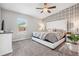 Serene main bedroom with a luxurious bed, patterned wallpaper, and natural light at 1725 Sommarie Way, Tarpon Springs, FL 34689