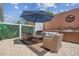 Inviting outdoor patio with comfortable seating, stylish decor, and a large shade umbrella at 1725 Sommarie Way, Tarpon Springs, FL 34689