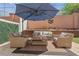 Inviting outdoor patio with comfortable seating, stylish decor, and a large shade umbrella at 1725 Sommarie Way, Tarpon Springs, FL 34689