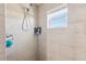 Modern bathroom shower with stylish tile, sleek fixtures, and natural light from the window at 1725 Sommarie Way, Tarpon Springs, FL 34689