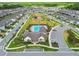 Aerial community view featuring a pool, clubhouse, playground, and neatly arranged residential streets and homes at 17652 Ramble On Way, Land O Lakes, FL 34638