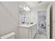 Bright bathroom featuring a large mirror over the sink and a gray wood grain floor at 17652 Ramble On Way, Land O Lakes, FL 34638