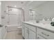Bathroom with white cabinets, granite counters, shower and bathtub combination, and neutral tiling at 17652 Ramble On Way, Land O Lakes, FL 34638