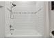 A well lit bathroom features a shower and tub area with modern white subway tiles at 17652 Ramble On Way, Land O Lakes, FL 34638