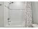 This bathroom features a tiled shower and tub with a multicolored shower curtain at 17652 Ramble On Way, Land O Lakes, FL 34638