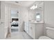 Bright bathroom with double sink vanity and a view into the bedroom through an open doorway at 17652 Ramble On Way, Land O Lakes, FL 34638