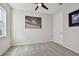 This bedroom features neutral walls, gray carpet, and a modern ceiling fan at 17652 Ramble On Way, Land O Lakes, FL 34638