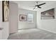 Empty bedroom with neutral walls, carpeted floors, a ceiling fan and a window view at 17652 Ramble On Way, Land O Lakes, FL 34638