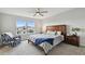 Light-filled bedroom with large window, cozy chair, and coordinated modern furnishings at 17652 Ramble On Way, Land O Lakes, FL 34638