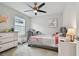 This bedroom features a bed with a gray frame, a dresser, and neutral walls at 17652 Ramble On Way, Land O Lakes, FL 34638
