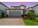 Charming two-story home with a brick paver driveway, two car garage and well manicured landscaping at 17652 Ramble On Way, Land O Lakes, FL 34638