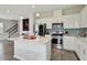 Bright kitchen with white cabinets, stainless steel appliances, center island, and open layout at 17652 Ramble On Way, Land O Lakes, FL 34638
