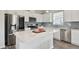 Bright kitchen with stainless steel appliances, white cabinets, a subway tile backsplash, and a center island at 17652 Ramble On Way, Land O Lakes, FL 34638