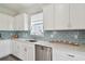 Modern kitchen features stainless steel appliances, white cabinetry, subway tile backsplash, and quartz countertops at 17652 Ramble On Way, Land O Lakes, FL 34638