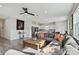 Bright living room featuring hardwood floors, a modern kitchen, dining area, and large comfortable sectional at 17652 Ramble On Way, Land O Lakes, FL 34638