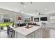 Open-concept living space featuring a kitchen island, dining table, and comfortable seating area at 17652 Ramble On Way, Land O Lakes, FL 34638