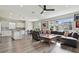 Spacious living room featuring an open layout with a modern kitchen, dining area, and large sectional sofa at 17652 Ramble On Way, Land O Lakes, FL 34638