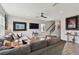 Comfortable living room with gray sofa, wood floors, staircase, and stylish decor throughout at 17652 Ramble On Way, Land O Lakes, FL 34638