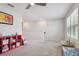 Open loft area with neutral walls, carpeted floors, and natural light from large windows at 17652 Ramble On Way, Land O Lakes, FL 34638