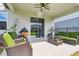 Relaxing covered patio with a ceiling fan, wicker seating, a grill, and a sliding glass door to the house at 17652 Ramble On Way, Land O Lakes, FL 34638
