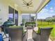 Cozy covered patio with comfortable wicker furniture, a built-in grill, and a view of the backyard at 17652 Ramble On Way, Land O Lakes, FL 34638