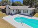 Backyard featuring a kidney shaped pool with a large deck and screened in patio at 2204 Jennifer Ln, Valrico, FL 33594